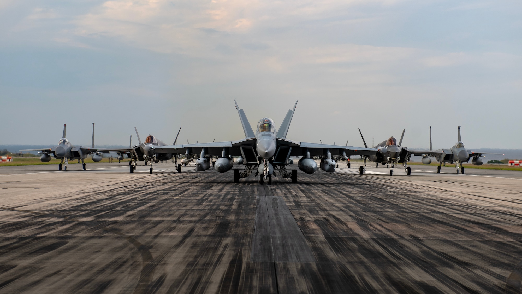 U.S. military aircraft line up on the runway during an elephant walk at Kadena Air Base, Japan, Nov. 21, 2023. The exercise showcased the 18th Wing’s collective readiness and ability to generate combat airpower at a moment's notice to ensure regional stability throughout the Indo-Pacific. (U.S. Air Force photo by Staff Sgt. Roth)