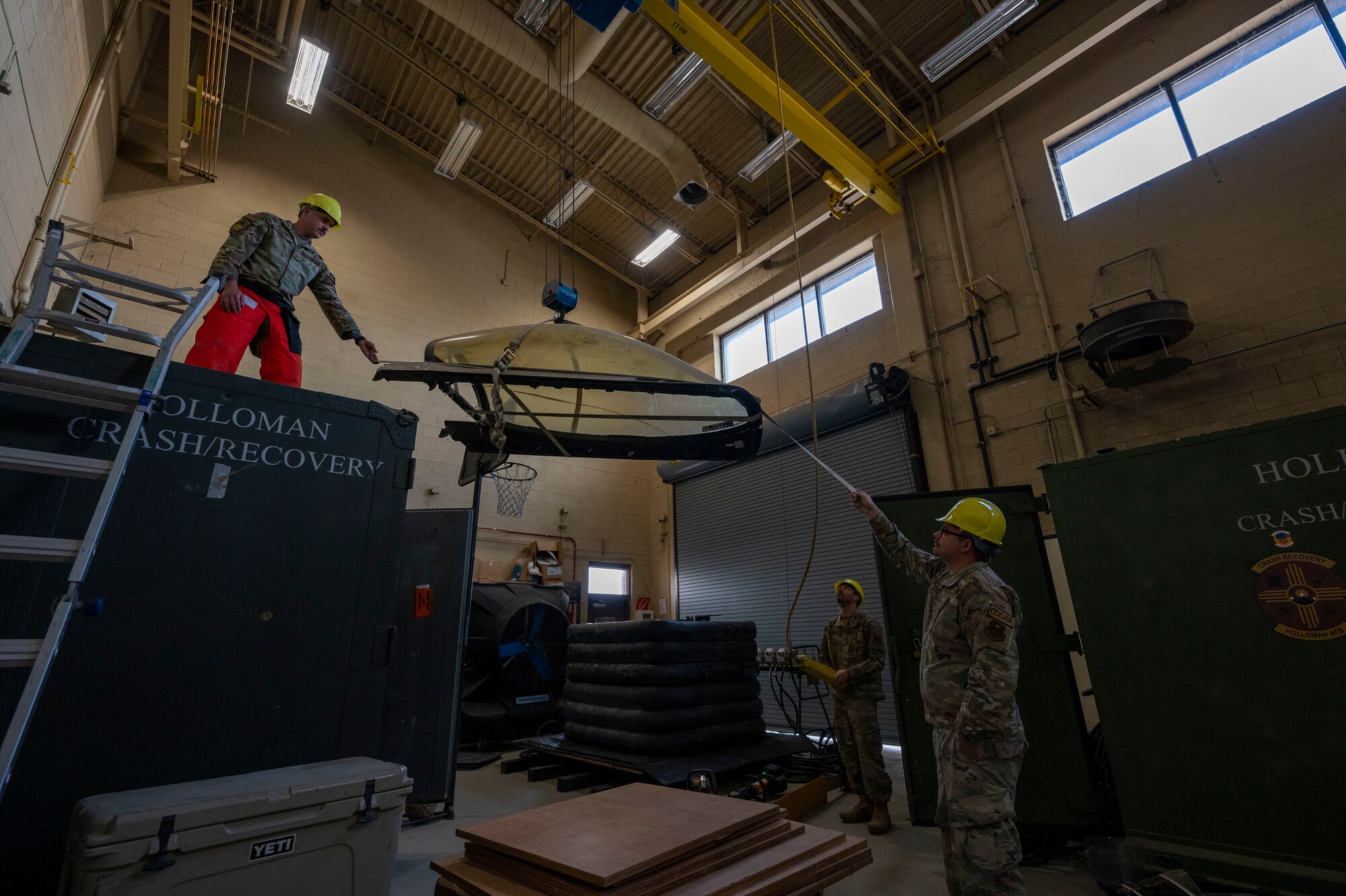 Airmen from the 49th Equipment Maintenance Squadron crash recovery team lift the canopy of an F-16 Viper for an exercise at Holloman Air Force Base, New Mexico, Nov. 20, 2023.In the event of an aircraft mishap, the 49th EMS team swiftly mobilizes, bringing their extensive skills in troubleshooting and repairing aircraft structures and systems to ensure quick and safe recovery of the damaged assets (U.S. Air Force photo by Airman 1st Class Isaiah Pedrazzini)