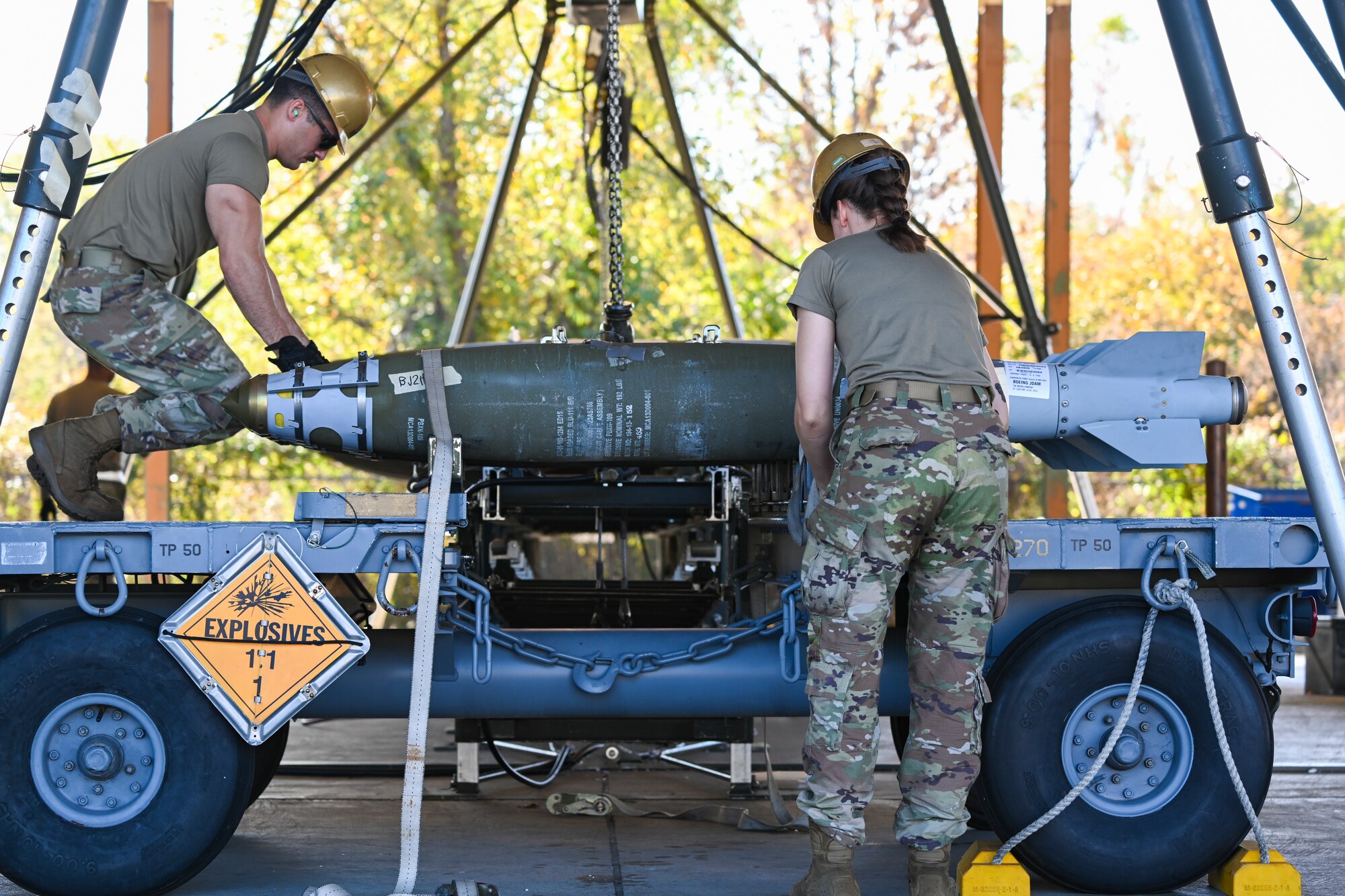 Airmen from the 2nd Munitions Squadron trailer load live GBU-38 weapons from a munitions assembly conveyor during a Combat Ammunition Production Exercise on Nov. 7, 2023 at Barksdale Air Force Base, La. During CAPEX Airmen practice rapid weapons production during simulated sustained combat operations. (U.S. Air Force Photo by Senior Airman Nia Jacobs)