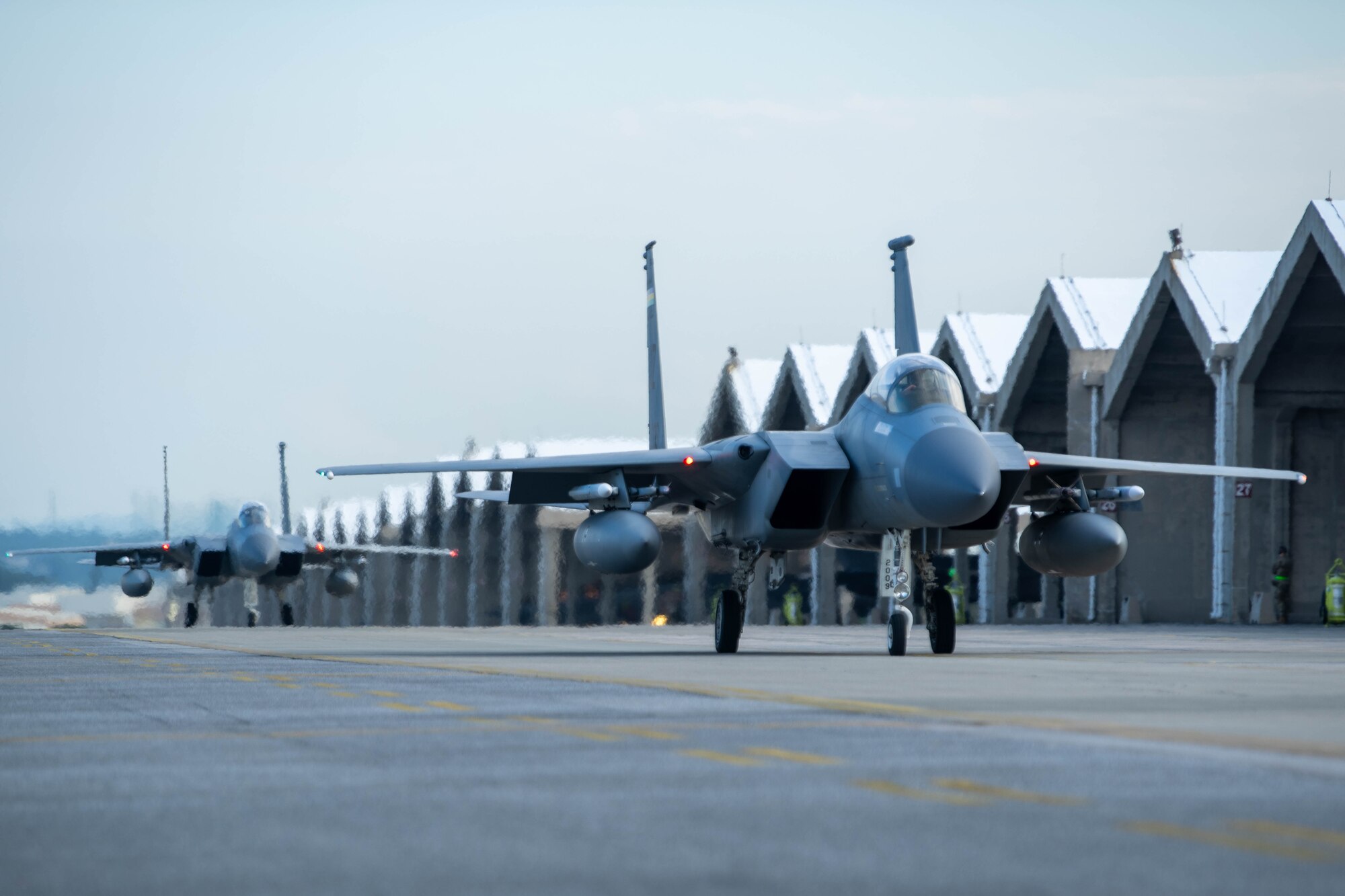 Two F-15C taxi to flightline