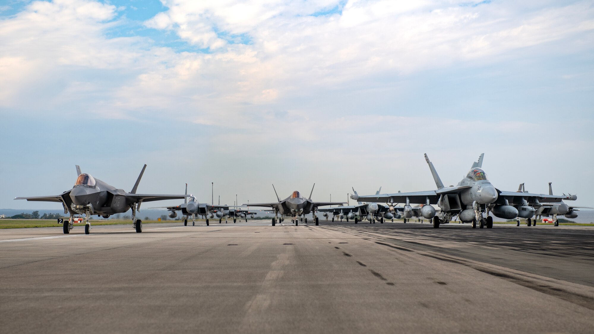 U.S. military aircraft line up on the runway during an elephant walk at Kadena Air Base, Japan, Nov. 21, 2023. Similar training is routinely conducted at U.S. Air Force bases across Japan and around the globe to ensure U.S. Forces Japan’s readiness to respond to a range of potential contingencies. (U.S. Air Force photo by Staff Sgt. Roth)