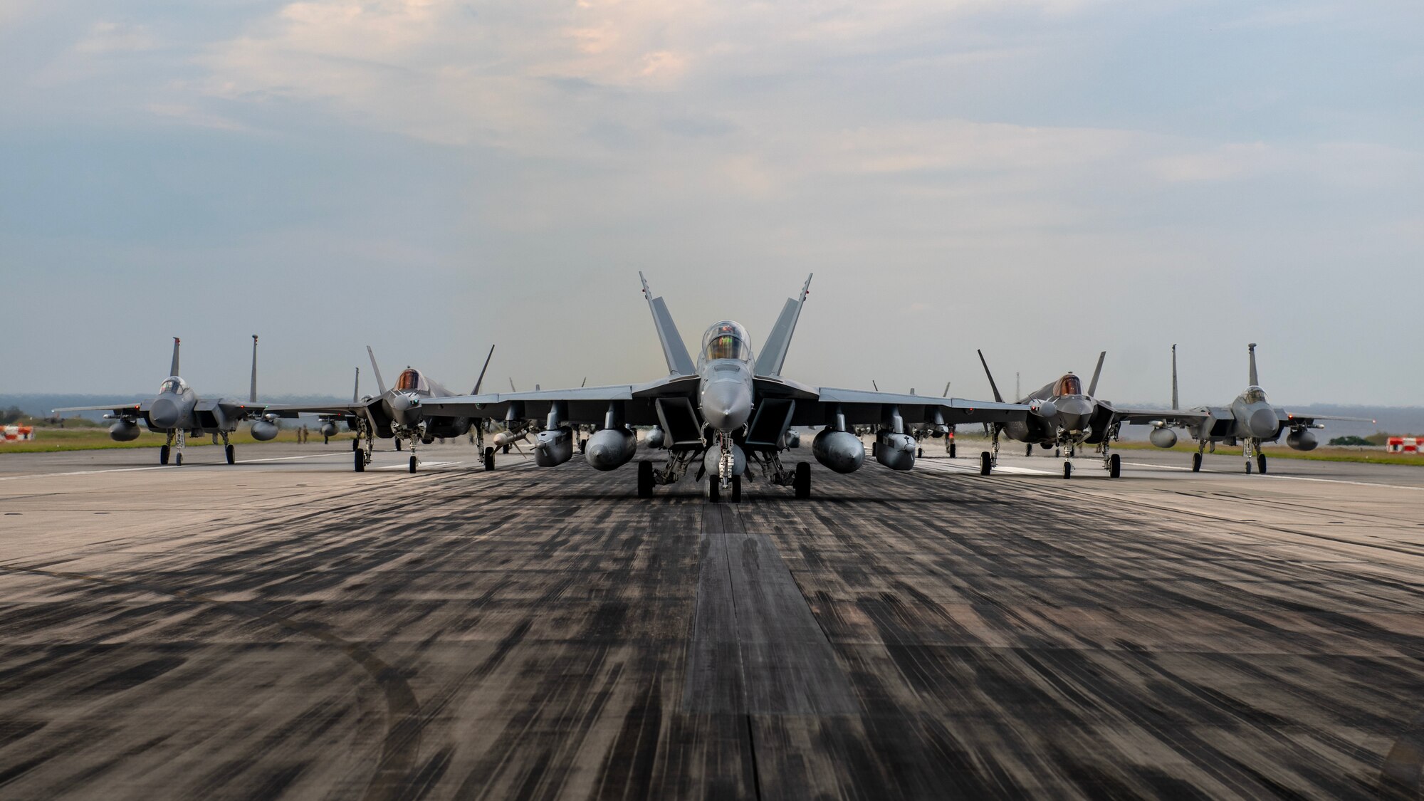 U.S. military aircraft line up on the runway during an elephant walk at Kadena Air Base, Japan, Nov. 21, 2023. The exercise showcased the 18th Wing’s collective readiness and ability to generate combat airpower at a moment's notice to ensure regional stability throughout the Indo-Pacific. (U.S. Air Force photo by Staff Sgt. Roth)