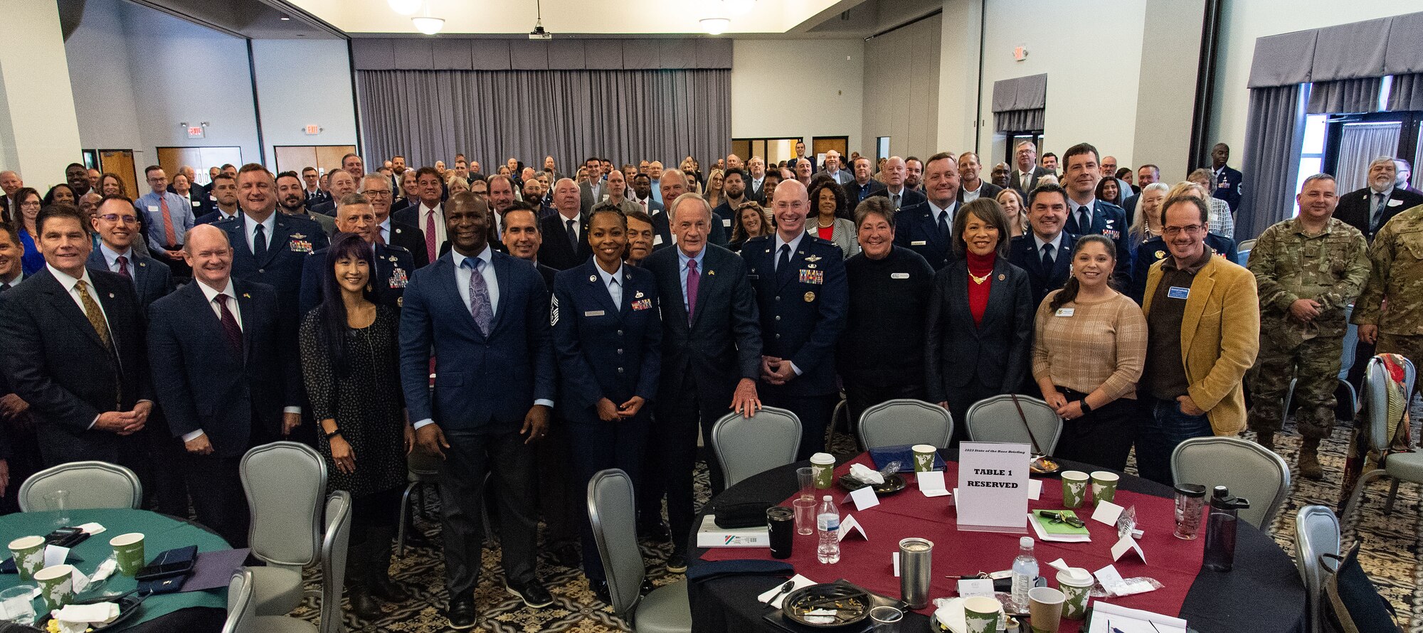 Team Dover members stand with U.S. congressional delegates from Delaware and Central Delaware Chamber of Commerce members, at the 2023 State of the Base briefing on Dover Air Force Base, Delaware, Nov. 20, 2023. The event was hosted by the CDCC and informed attendees on community partnership initiatives and the impact that Team Dover has on the state and local economies. (U.S. Air Force photo by Roland Balik)