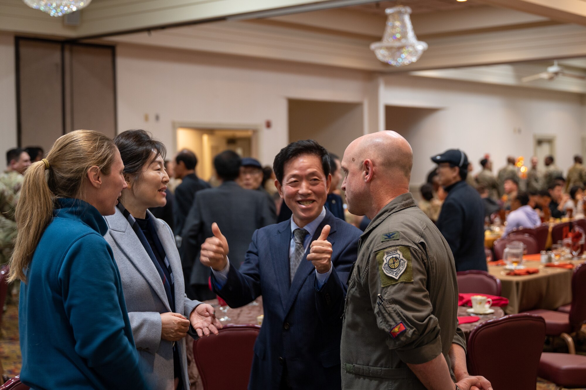From right, Col. Matthew C. Gaetke, Kang Dak-In, Rosemary Song and Col. Kathryn Gaetke converse ahead of an annual Thanksgiving meal hosted by KAGA.