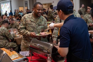 Tech. Sgt. Aaron Coleman eceives food during the annual Thanksgiving meal hosted by the Korean-American Gunsan Alliance.