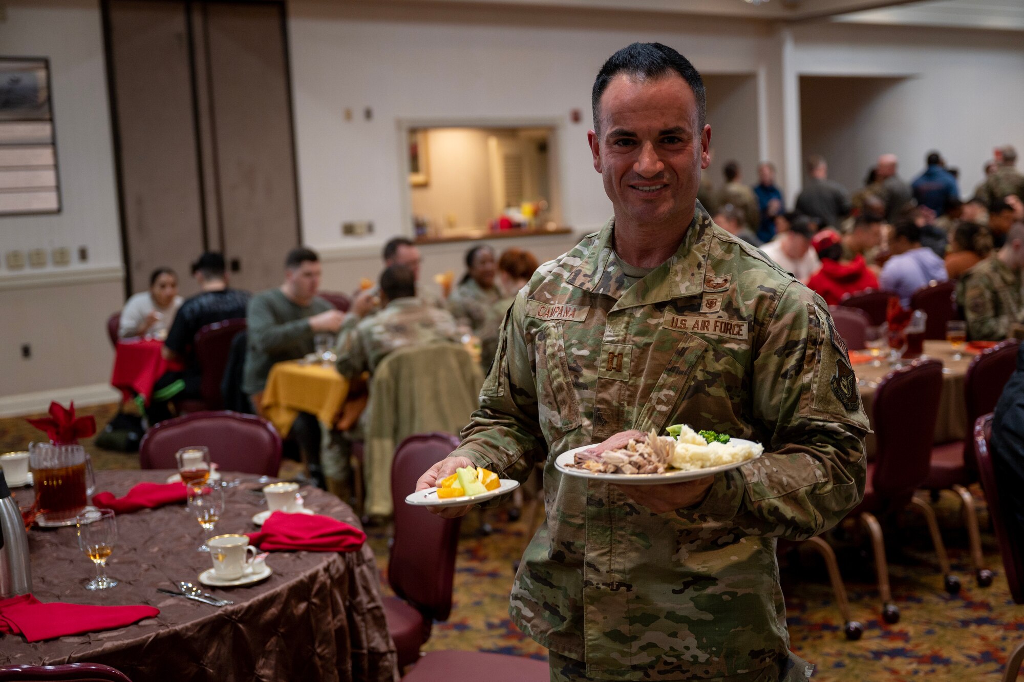 Capt. Joseph Campana carries food to a table during the annual Thanksgiving meal hosted by the Korean-American Gunsan Alliance.