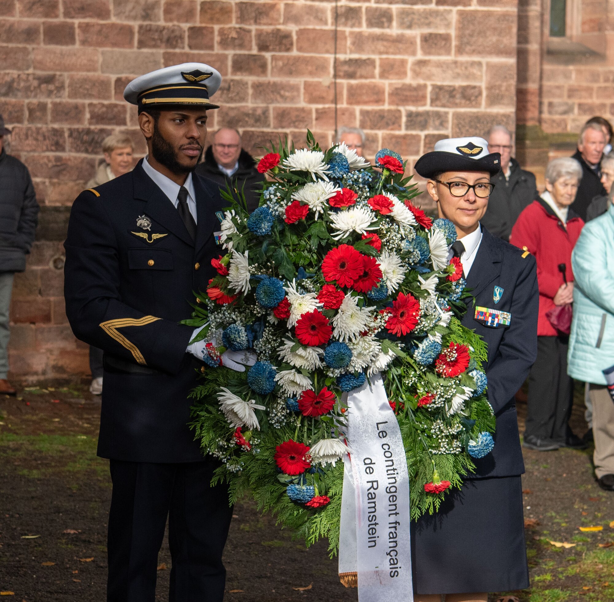 people hold wreath