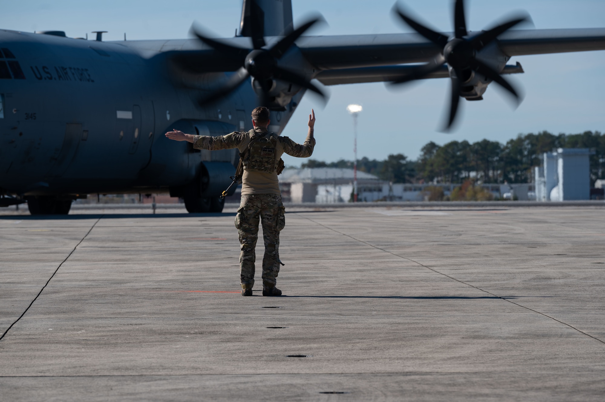 U.S. Air Force Airman assigned to the 4th Fighter Wing marshals a C-130 Hercules during Razor Talon 24-1 at Marine Corps Air Station Cherry Point, North Carolina, November 13, 2023. Razor Talon is an agile combat employment focused exercise, designed to test the 4th Fighter Wing’s ability to operate as a lead wing to generate combat airpower while continuing to move, maneuver, sustain the wing and subordinate force elements in a dynamic contested environment. (U.S. Air Force photo by Airman 1st Class Rebecca Sirimarco-Lang)