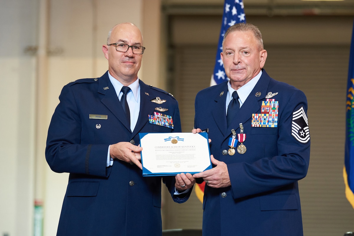 Lt. Col Randall Hood, left, deputy commander of the Kentucky Air National Guard’s 123rd Operations Group, presents a Kentucky Distinguished Service Medal to Chief Master Sgt. Danny Gregory, senior enlisted leader of the 165th Airlift Squadron’s Flight Engineer Section, during Gregory’s retirement ceremony at the Kentucky Air National Guard Base in Louisville, Ky., Sept. 9, 2023. Gregory retired from the 123rd Airlift Wing after more than 40 years in the military. (U.S. Air National Guard photo by Phil Speck)