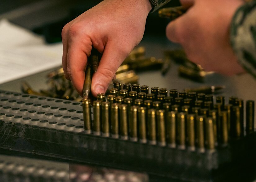 U.S. Air Force Senior Airman Eric Spruill, 633rd Security Forces Squadron installation entry controller, blocks ammunition at Joint Base Langley-Eustis, Virginia, Nov 8, 2023. Blocking ammo is a way to examine the ammo and ensure that it is safe to fire while simultaneously accounting for all used and unused ammo. (U.S. Air Force photo by Airman 1st Class Ian Sullens)