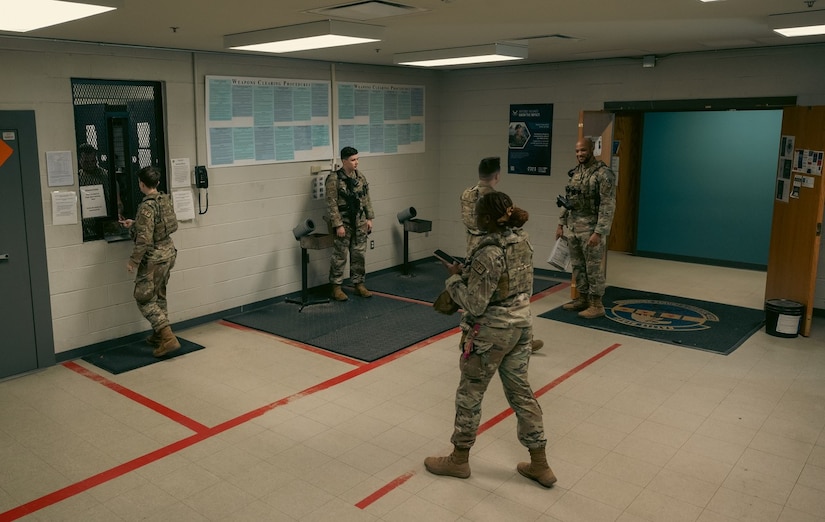 Airmen from the 633d Security Forces Squadron retrieve their firearms in the armory at Joint Base Langley-Eustis, Virginia, Nov 8, 2023. The SFS defenders must be armed before each shift, and the must relinquish their weapons when their shift is over. (U.S. Air Force photo by Airman 1st Class Ian Sullens)