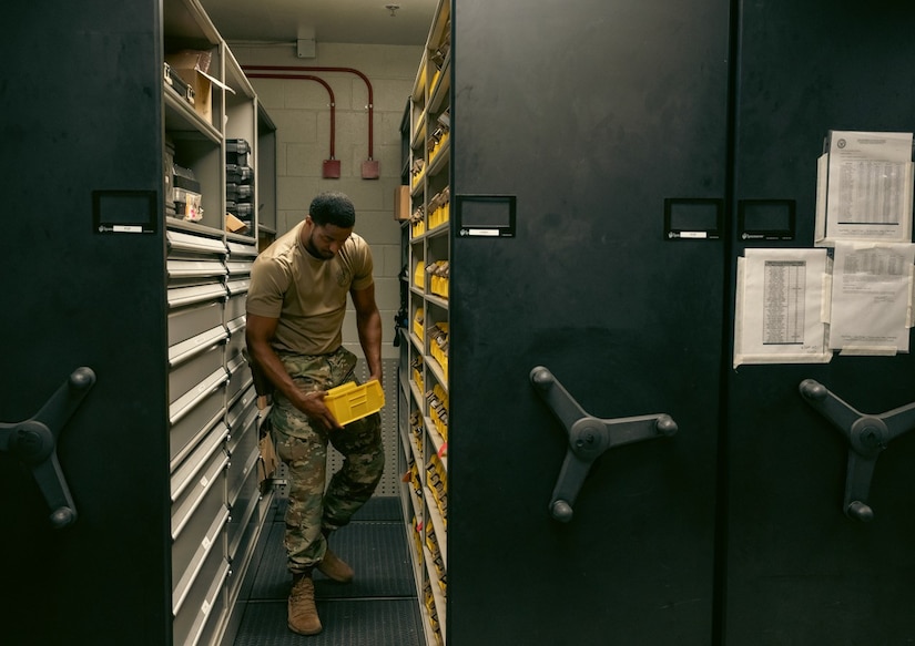 U.S. Air Force Airman 1st Class James Martin, 633rd Security Forces Squadron armorer, retrieves ammunition from the storage lockers at Joint Base Langley-Eustis, Virginia, Nov 8, 2023. Martin maintains, organizes, and distributes weapons and ammo SFS personnel to ensure security personnel are properly armed to defend the base. (U.S. Air Force photo by Airman 1st Class Ian Sullens)