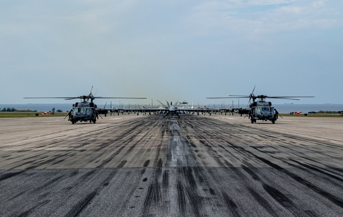 U.S. Air Force and U.S. Navy aircraft line up on the runway during an elephant walk