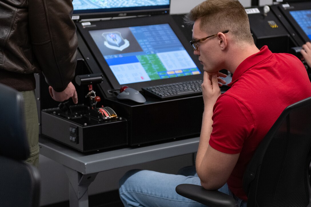 People work on computer monitors.