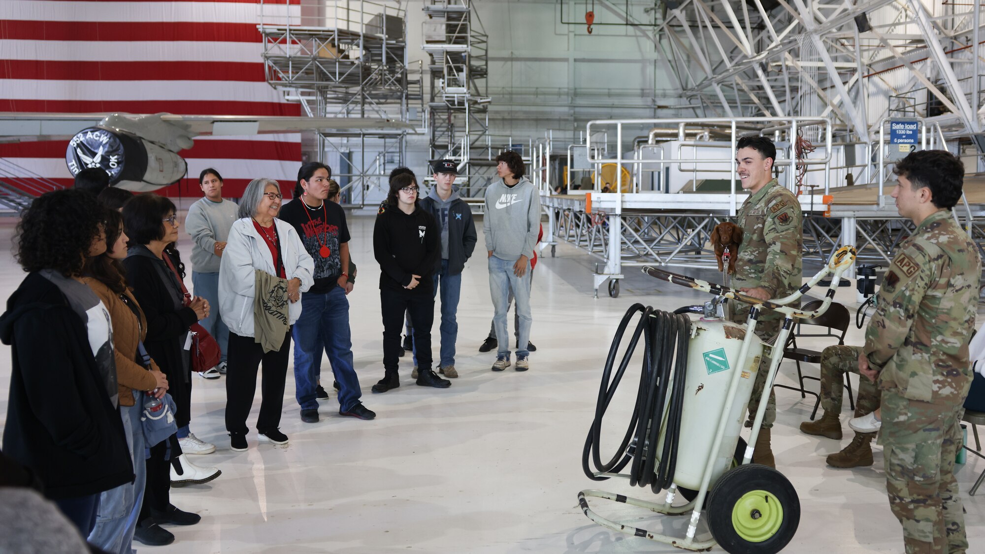 tour group members listen to airmen