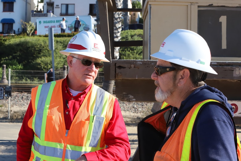 USACE contracting officer representative Dan Cook speaks with Manson safety manager Ed Smith.