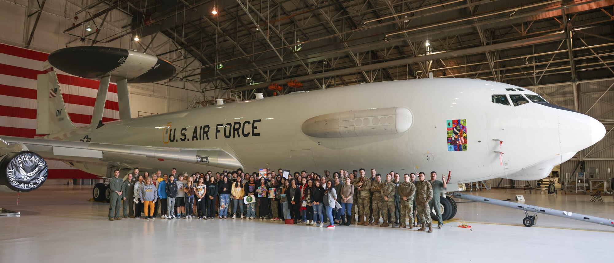 group photo in front of airplane