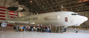 group photo in front of airplane