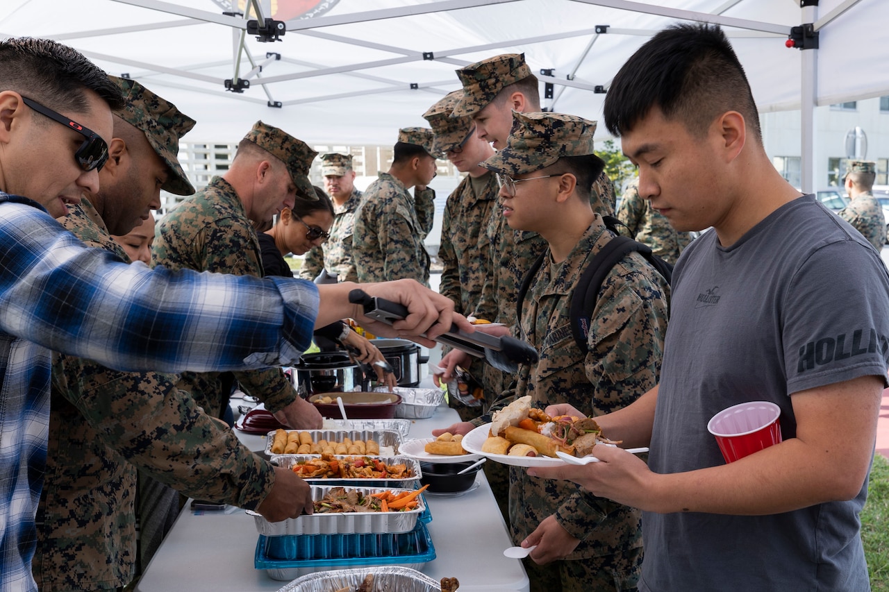 Service members line up for a Thanksgiving buffet.