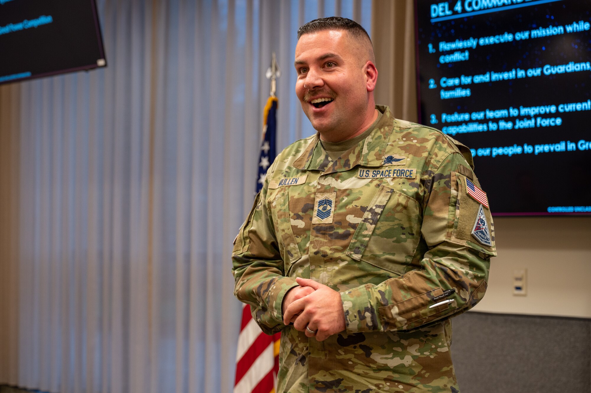 Service Member Speaks in from of a window