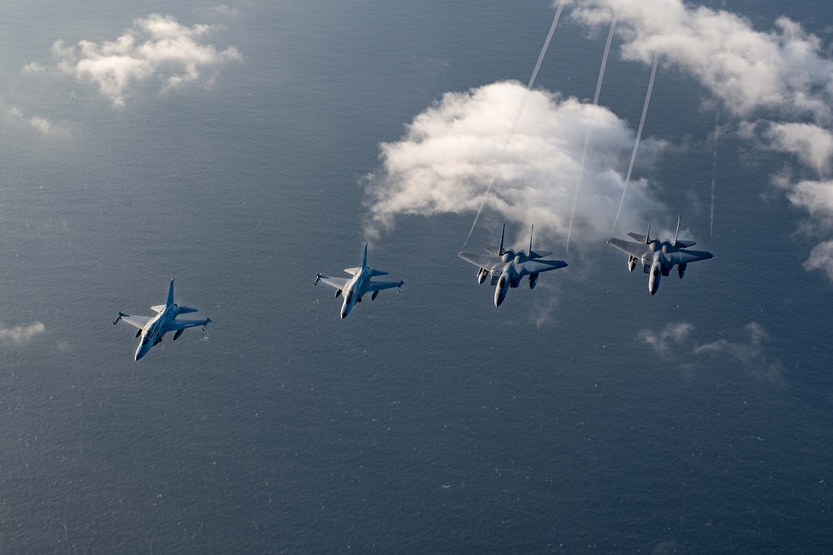 U.S. Air Force F-15s and Philippine Air Force FA-50s fly in formation in the vicinity of the South China Sea in support of a three-day maritime and aerial cooperation activity, Nov. 21-23. The maritime and aerial cooperation activity demonstrates the Armed Forces of the Philippines and U.S. Indo-Pacific Command’s commitment to a free and open Indo-Pacific Region. U.S. forces routinely operate with Allies and partners in defense of the rules-based international order and will continue to do so to maintain peace and stability in the region. (U.S. Air Force photo by Airman 1st Class Alexis Redin)