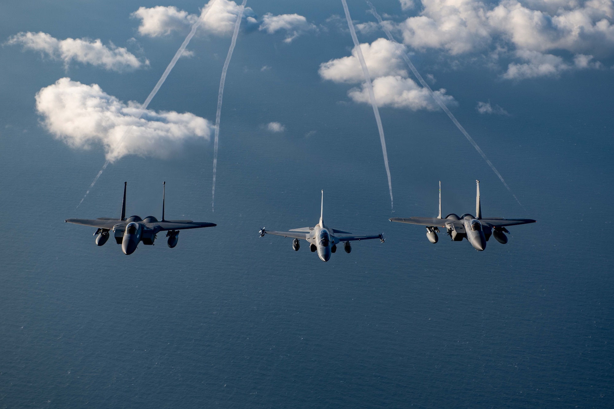 U.S. Air Force F-15s and Philippine Air Force FA-50s fly in formation in the vicinity of the South China Sea in support of a three-day maritime and aerial cooperation activity, Nov. 21-23. The maritime and aerial cooperation activity demonstrates the Armed Forces of the Philippines and U.S. Indo-Pacific Command’s commitment to a free and open Indo-Pacific Region. U.S. forces routinely operate with Allies and partners in defense of the rules-based international order and will continue to do so to maintain peace and stability in the region. (U.S. Air Force photo by Airman 1st Class Alexis Redin)