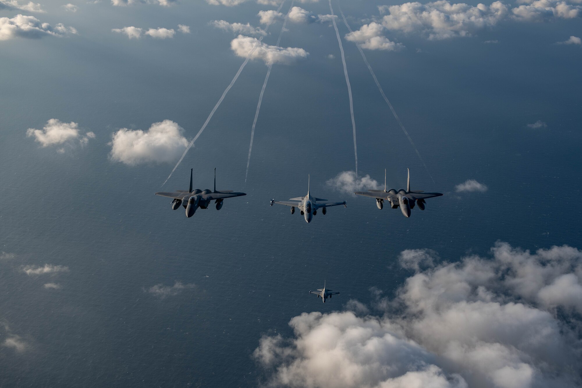 U.S. Air Force F-15s and Philippine Air Force FA-50s fly in formation in the vicinity of the South China Sea in support of a three-day maritime and aerial cooperation activity, Nov. 21-23. The maritime and aerial cooperation activity demonstrates the Armed Forces of the Philippines and U.S. Indo-Pacific Command’s commitment to a free and open Indo-Pacific Region. U.S. forces routinely operate with Allies and partners in defense of the rules-based international order and will continue to do so to maintain peace and stability in the region. (U.S. Air Force photo by Airman 1st Class Alexis Redin)