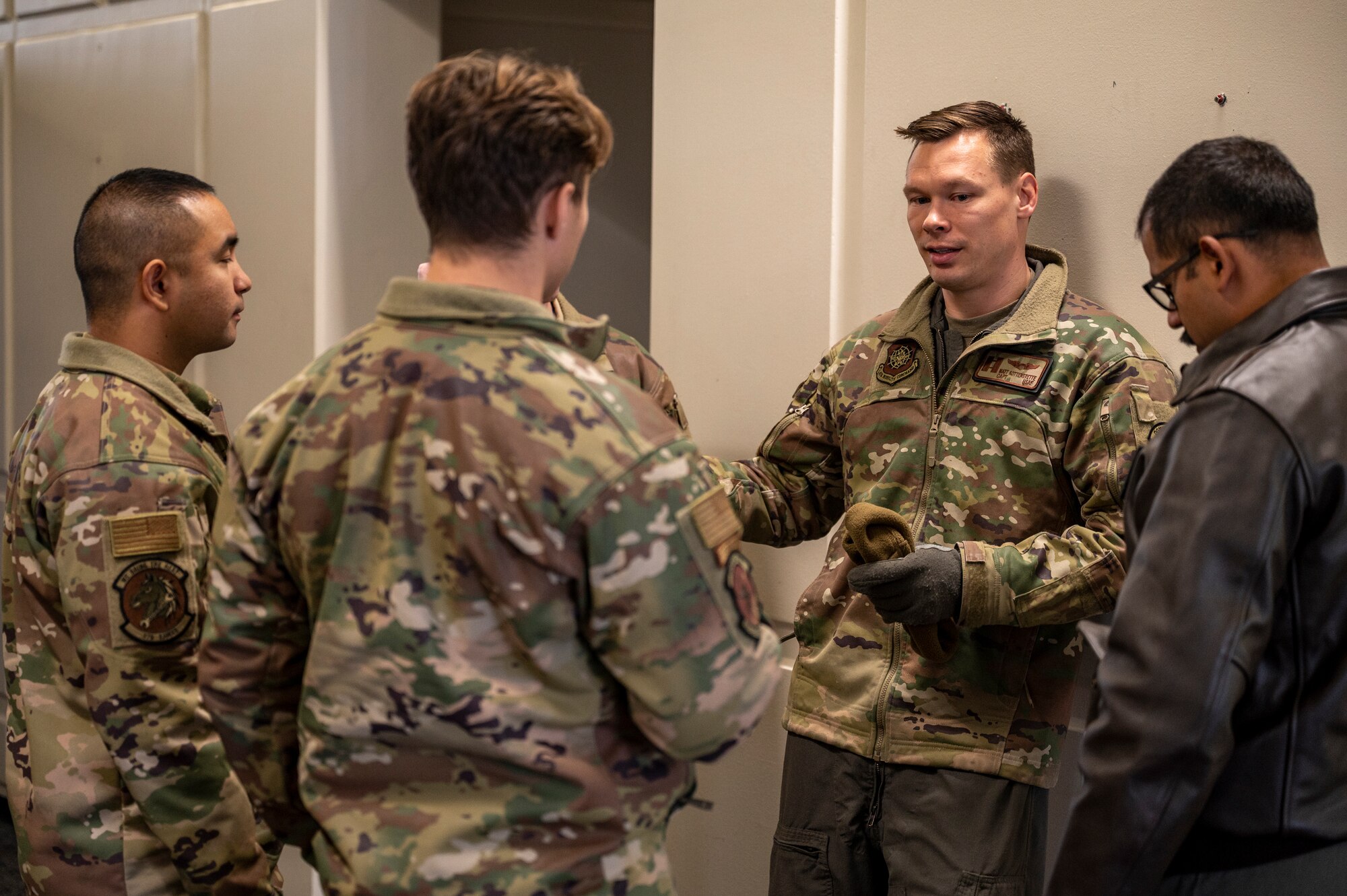 Airmen stand by in a building