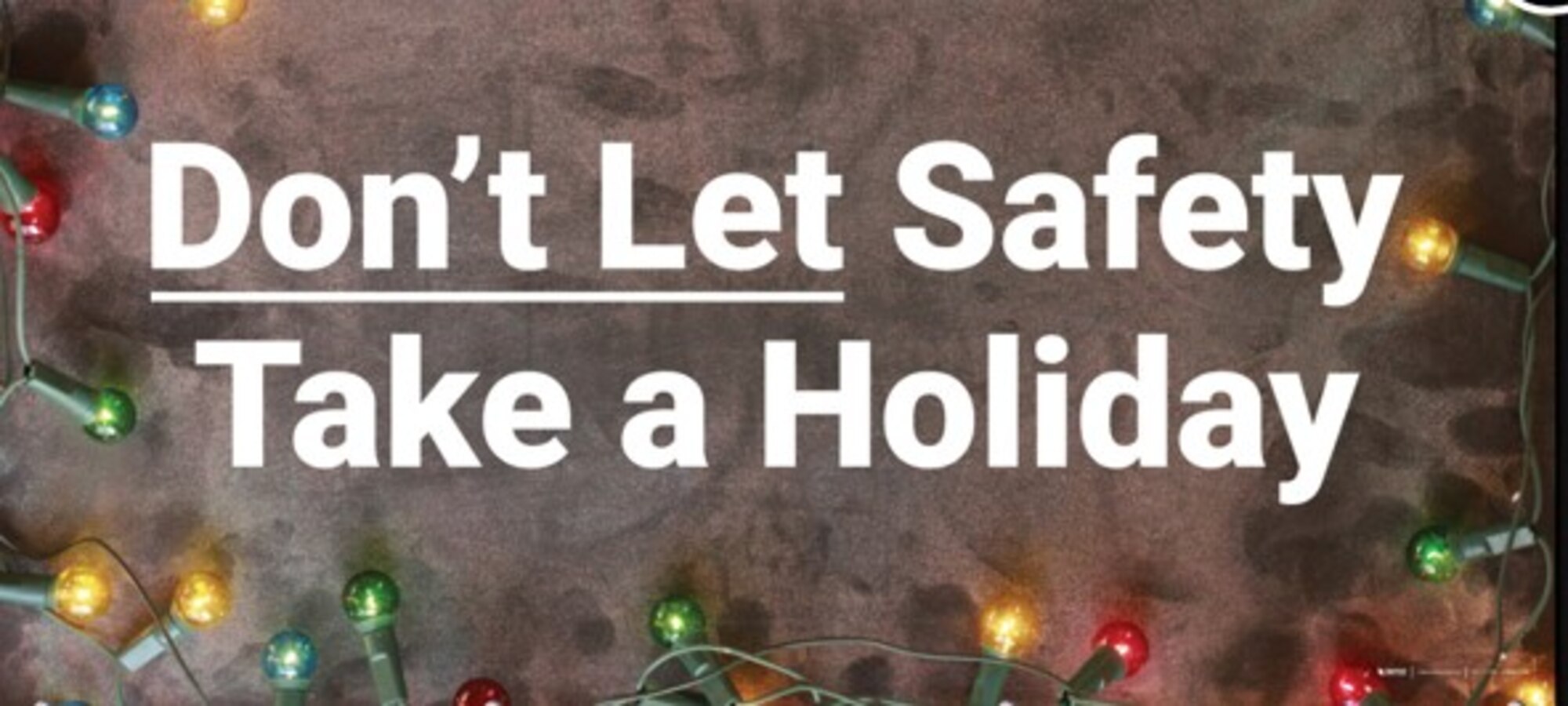 A black sign with the words Don't let Safety take a holiday