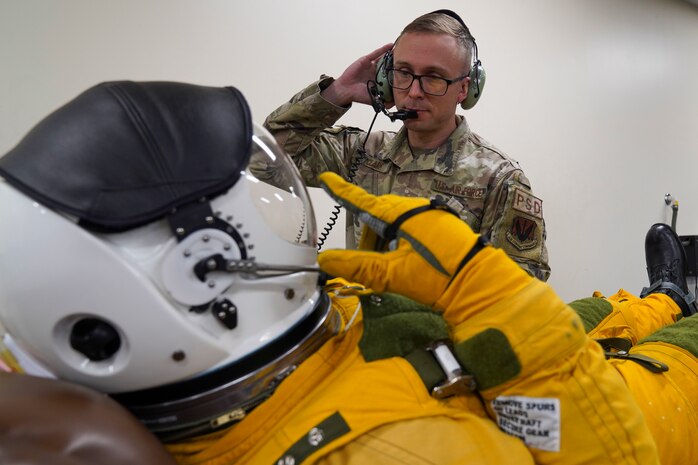 U.S. Air Force Tech. Sgt. Benjamin Clark, 9th Physiological Support Squadron launch and recovery supervisor, communicates with a U-2 Dragon Lady pilot through a headset, Nov. 16, 2023 at Beale Air Force Base, California.