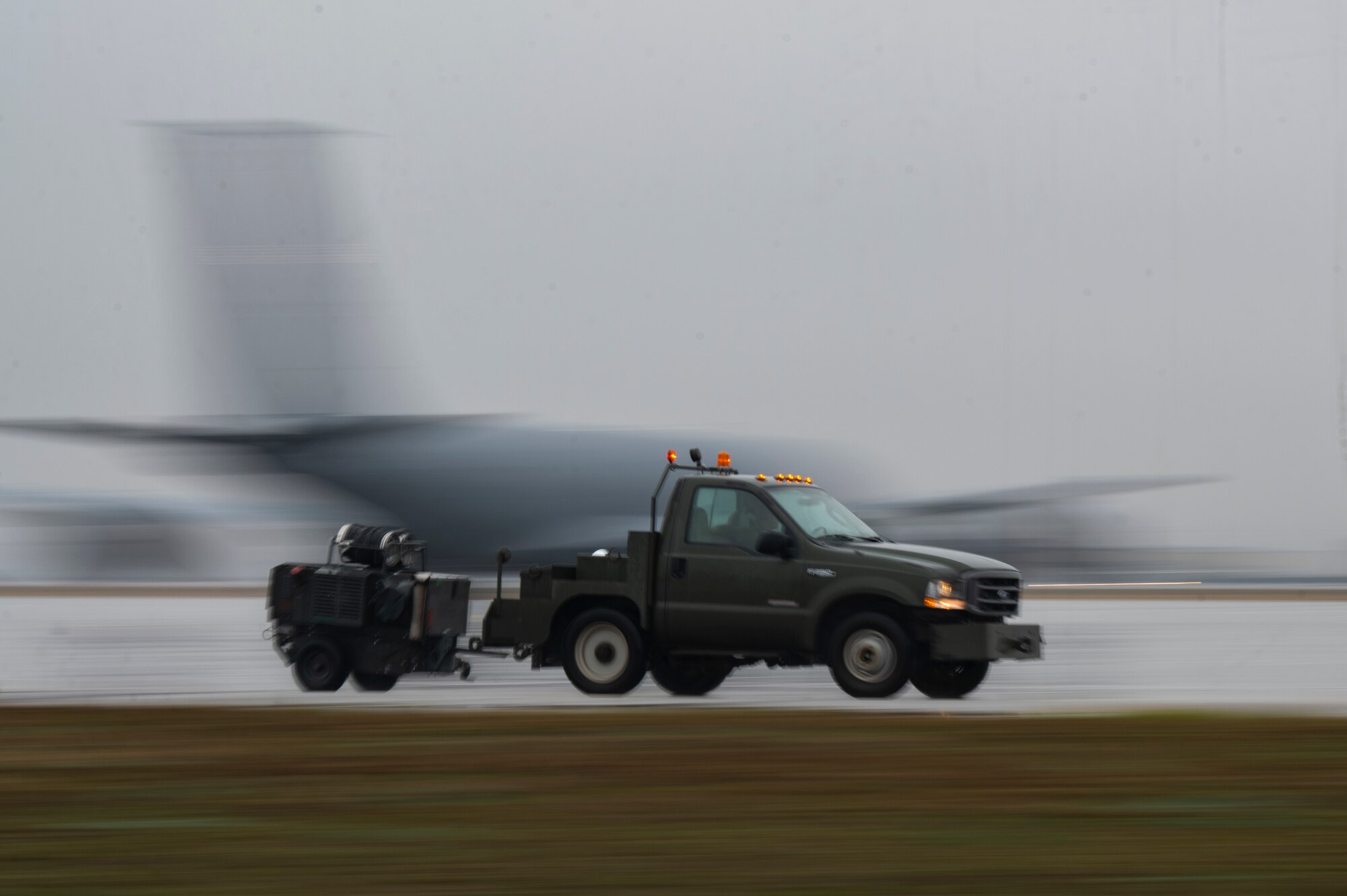 A truck drives on flightline