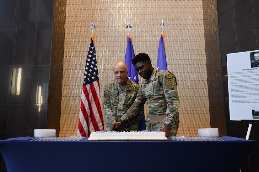 Two people cutting cake.