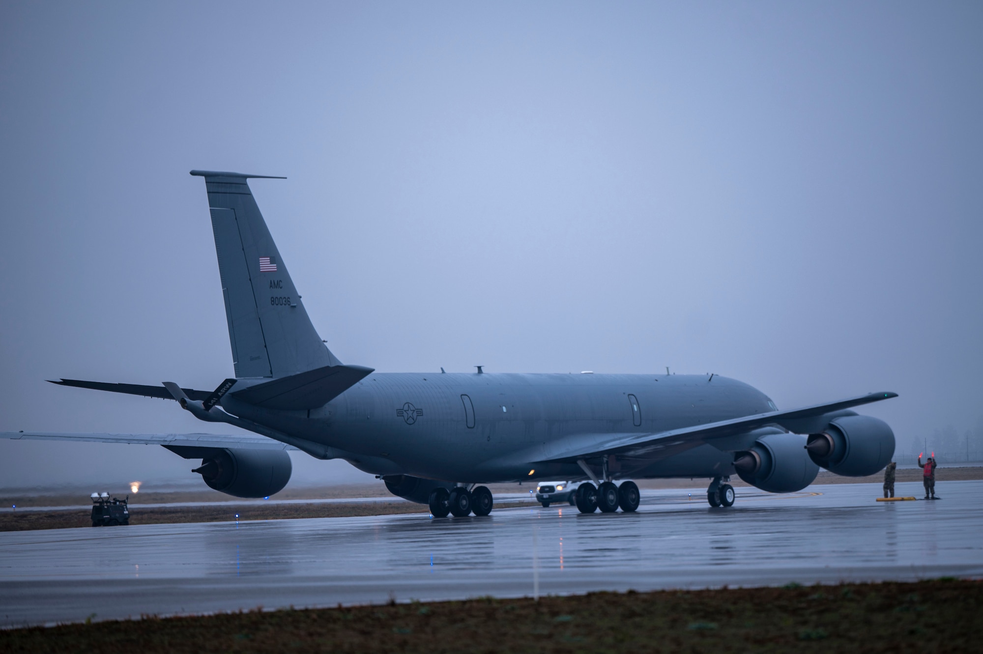 Airmen marshal an aircraft on the flightline.