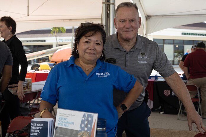 Angie Condon, left, the strategic partnerships manager at Western Governors University, and Kevin Nolan, the academic relationship manager at Purdue University, pose for a photo during the Fall Education Fair, Marine Corps Base Hawaii, Nov. 15, 2023. The fair offered service members and civilians an opportunity to learn more about educational benefits in the military and meet with college representatives from around the country. (U.S. Marine Corps photo by Lance Cpl. Tania Guerrero)