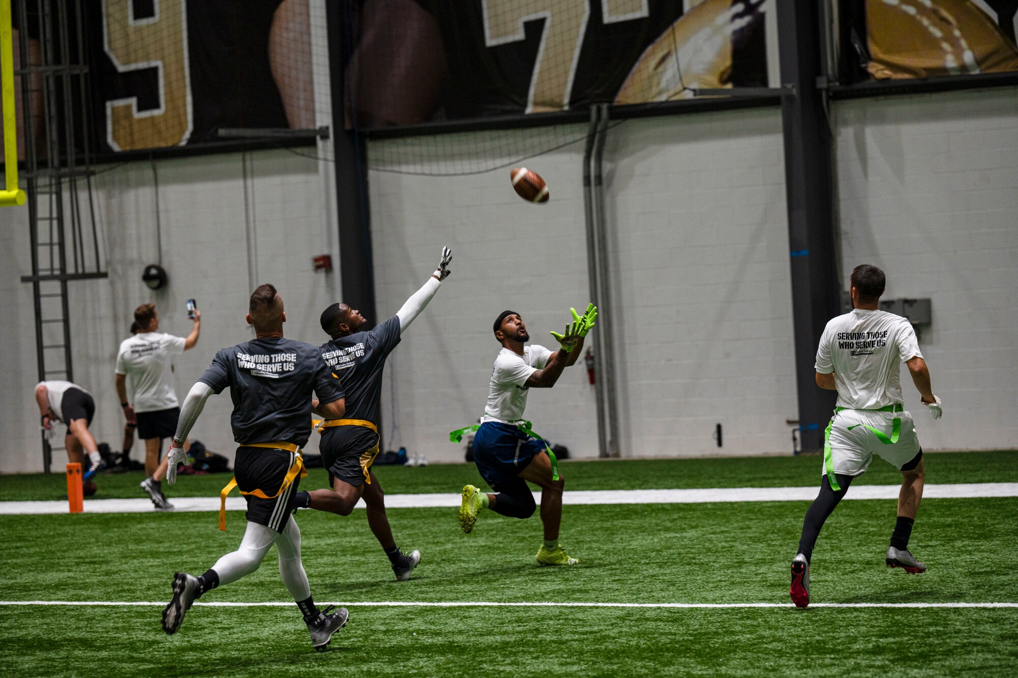 Armed Forces members try to catch football during Battle of the Branches event