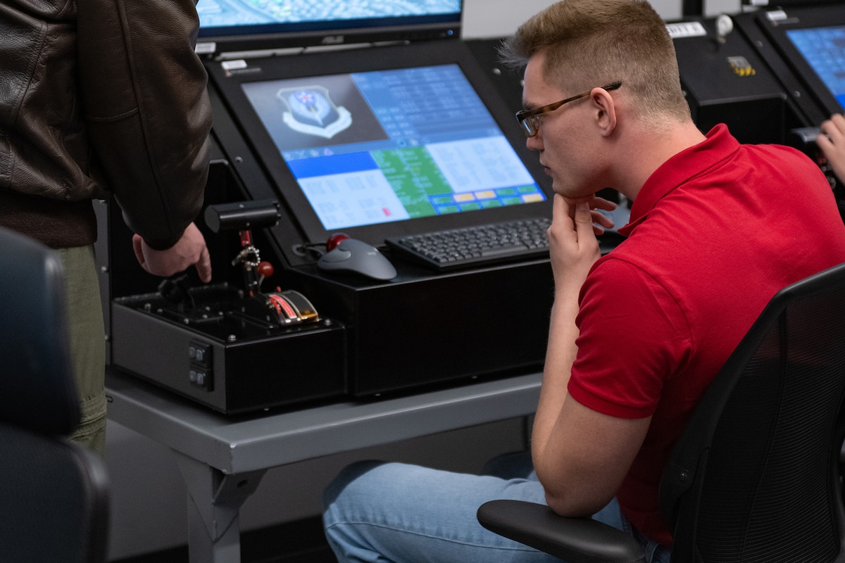 People work on computer monitors.