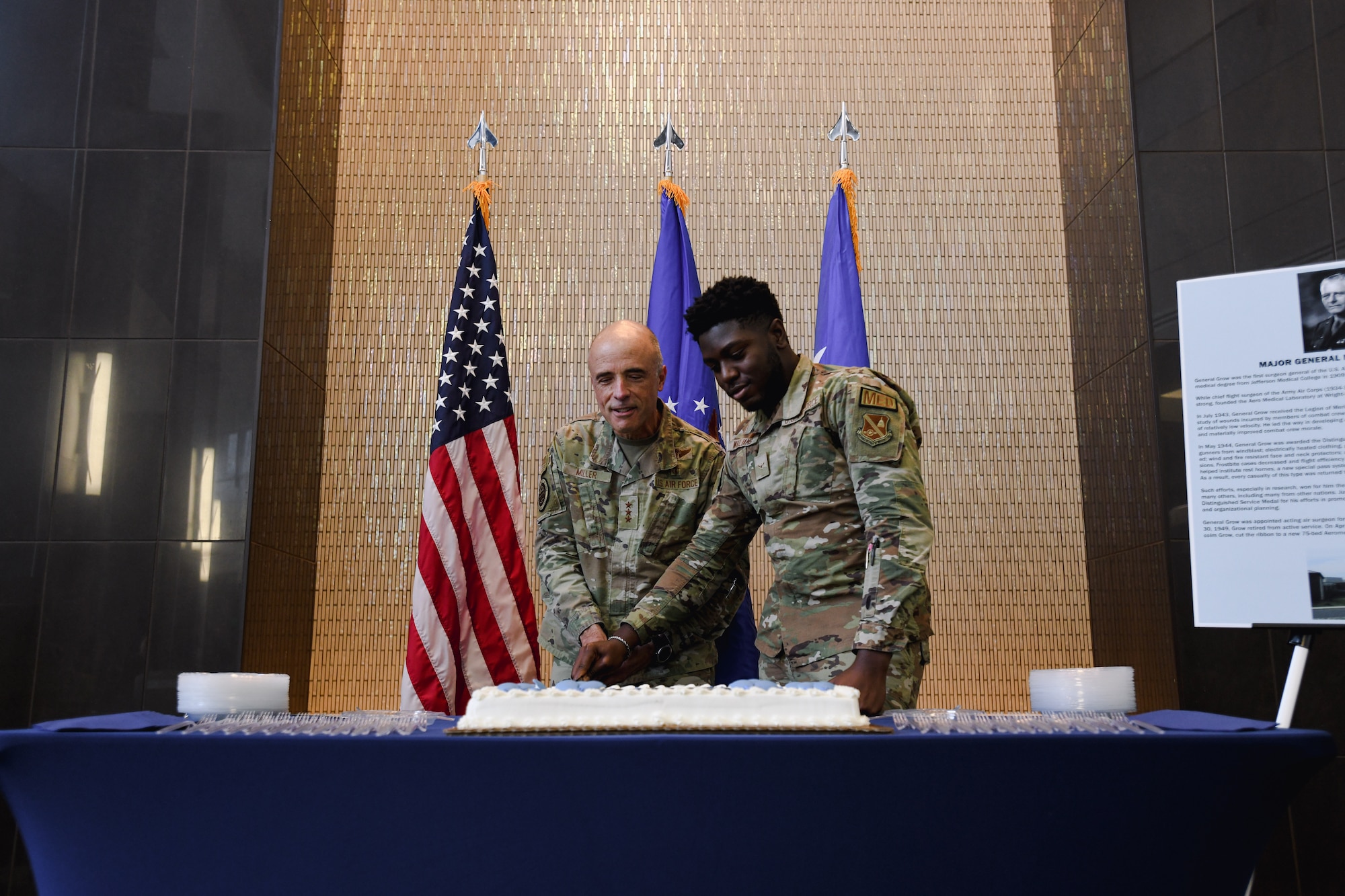 Two people cutting cake.