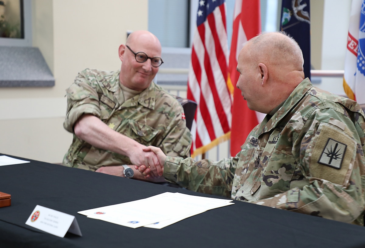 Danish Maj. Gen. Søren Andersen, commander of Denmark’s Joint Arctic Command, left, and Army Maj. Gen. Ray Shields, the adjutant general of New York, shake hands at New York National Guard headquarters in Latham Nov. 7, 2023, after signing a statement of intent to establish joint training and exchanges in Greenland.