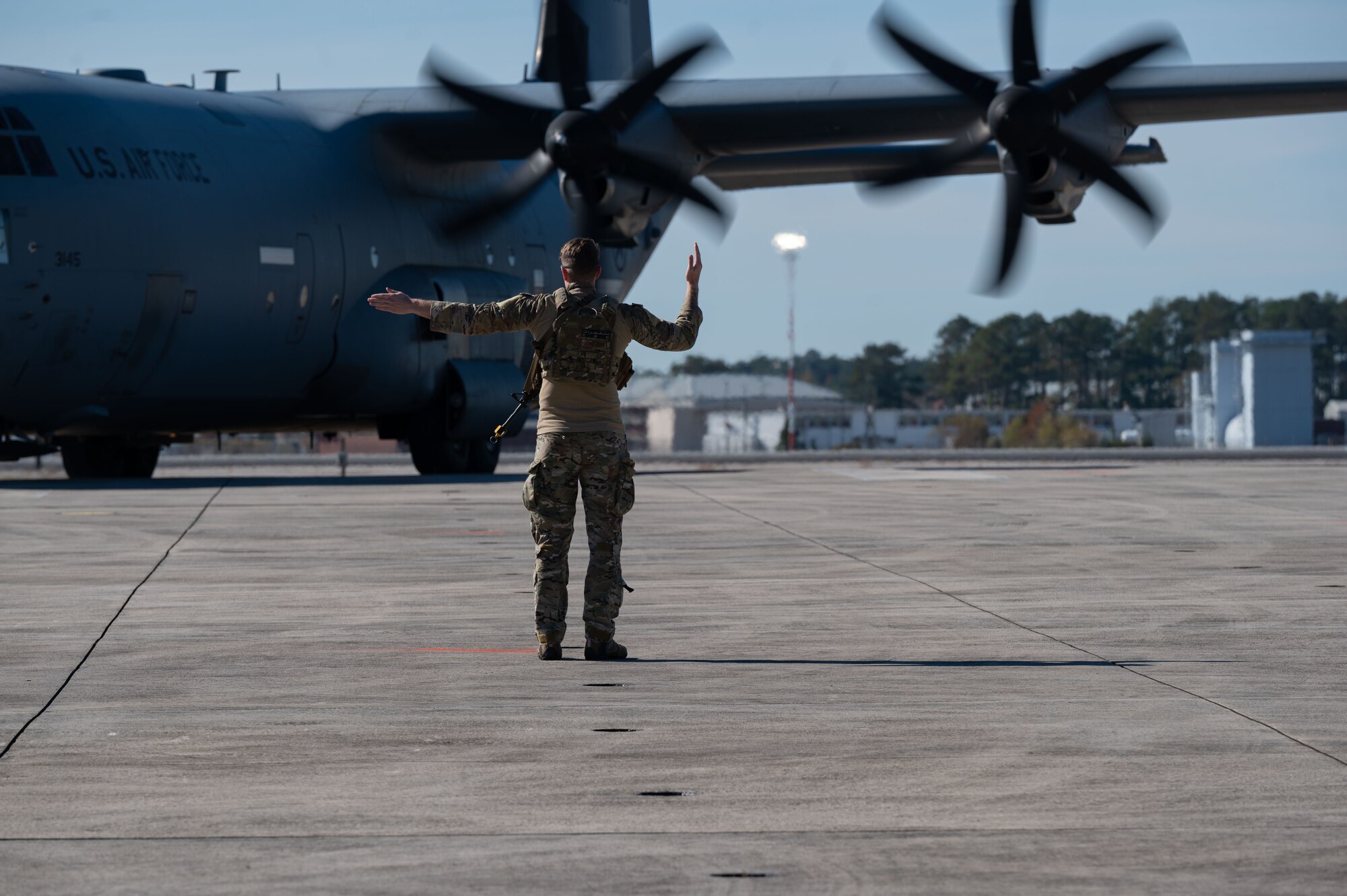 U.S. Air Force Airman assigned to the 4th Fighter Wing marshals a C-130 Hercules during Razor Talon 24-1 at Marine Corps Air Station Cherry Point, North Carolina, November 13, 2023. Razor Talon is an agile combat employment focused exercise, designed to test the 4th Fighter Wing’s ability to operate as a lead wing to generate combat airpower while continuing to move, maneuver, sustain the wing and subordinate force elements in a dynamic contested environment. (U.S. Air Force photo by Airman 1st Class Rebecca Sirimarco-Lang)