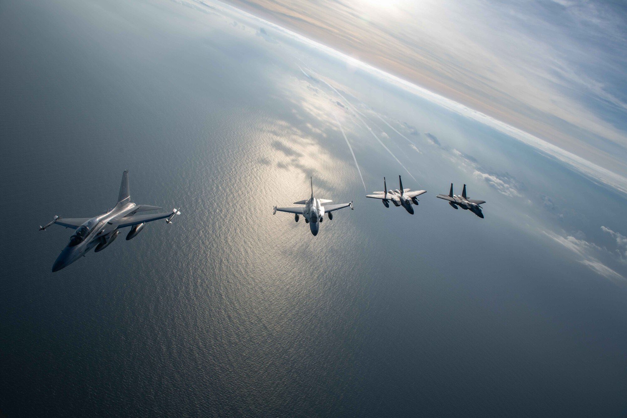 U.S. Air Force F-15s and Philippine Air Force FA-50s fly in formation in the vicinity of the South China Sea in support of a three-day maritime and aerial cooperation activity, Nov. 21-23. The maritime and aerial cooperation activity demonstrates the Armed Forces of the Philippines and U.S. Indo-Pacific Command’s commitment to a free and open Indo-Pacific Region. U.S. forces routinely operate with Allies and partners in defense of the rules-based international order and will continue to do so to maintain peace and stability in the region. (U.S. Air Force photo by Airman 1st Class Alexis Redin)