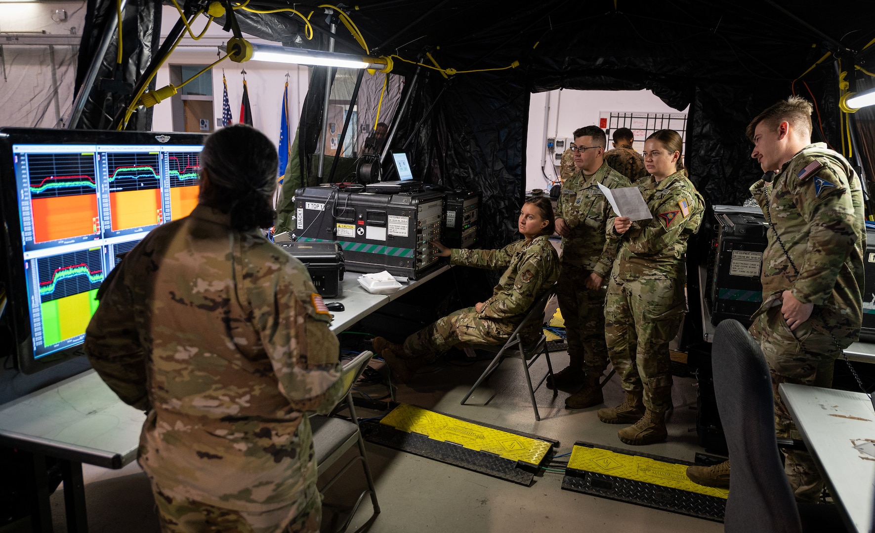 Military personnel assigned to the 527th/26th Space Aggressor Squadron and 2d Multi-Domain Task Force provide real-time monitoring of health and wellness for military satellites during Exercise HEAVY RAIN 23, Nov. 16, 2023 at Ramstein Air Base, Germany. HEAVY RAIN is a U.S. Air Forces in Europe-led command and control exercise that tests and evaluates communication and data-sharing capabilities among the joint force, NATO Allies and partners. (U.S. Air Force Photo by Senior Airman Edgar Grimaldo)