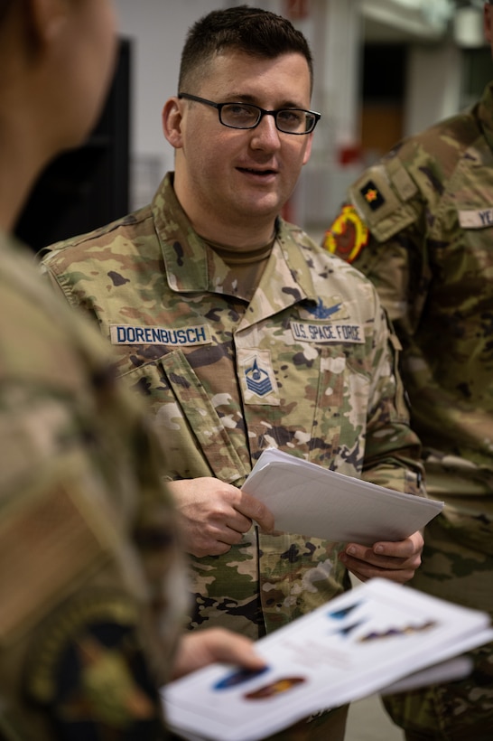 U.S. Space Force Master Sgt. Lane Dorenbusch, 527th Space Aggressor Squadron flight chief of weapons and tactics, briefs crew members on objectives and goals during Exercise HEAVY RAIN 23, Nov. 16, 2023 at Ramstein Air Base, Germany. HEAVY RAIN is a U.S. Air Forces in Europe-led command and control exercise that tests and evaluates communication and data-sharing capabilities among the joint force, NATO Allies and partners. (U.S. Air Force Photo by Senior Airman Edgar Grimaldo)