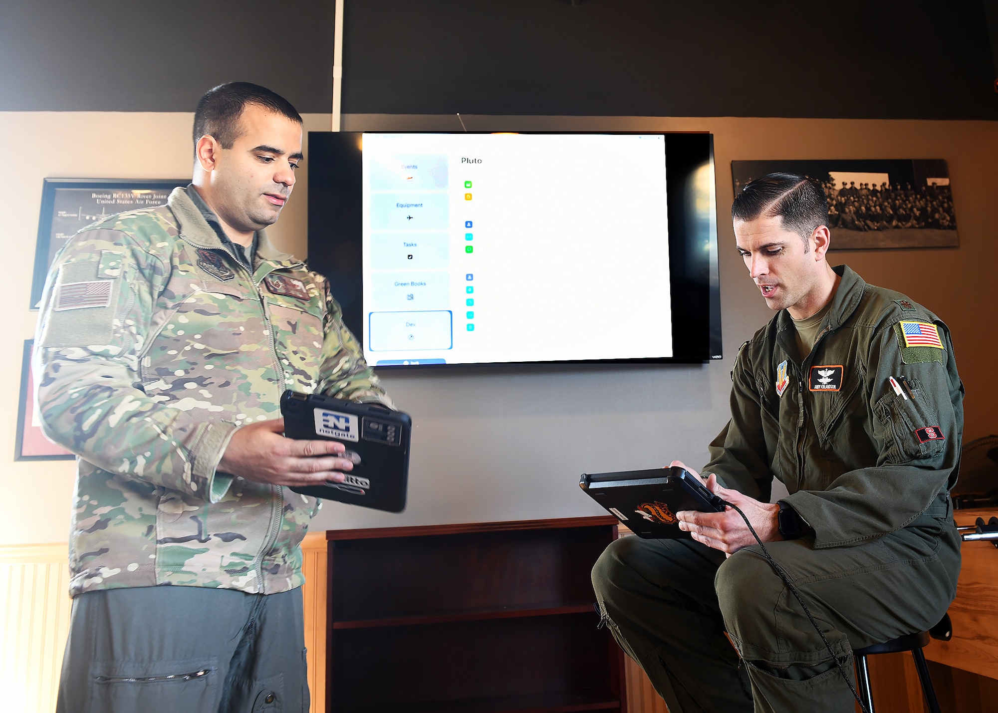 Airmen look at their tablets to test new application