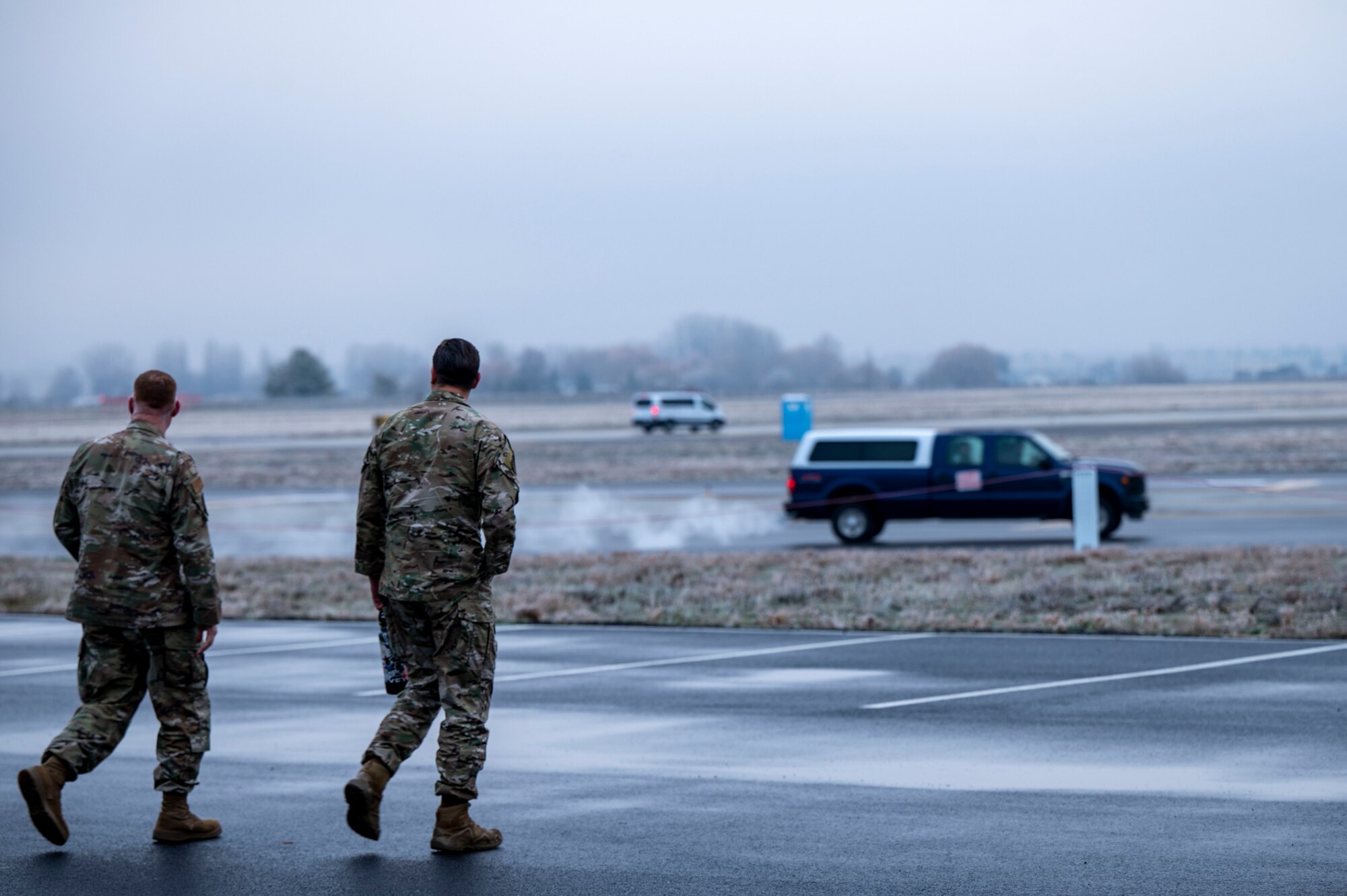 Airmen walk near the flightline.