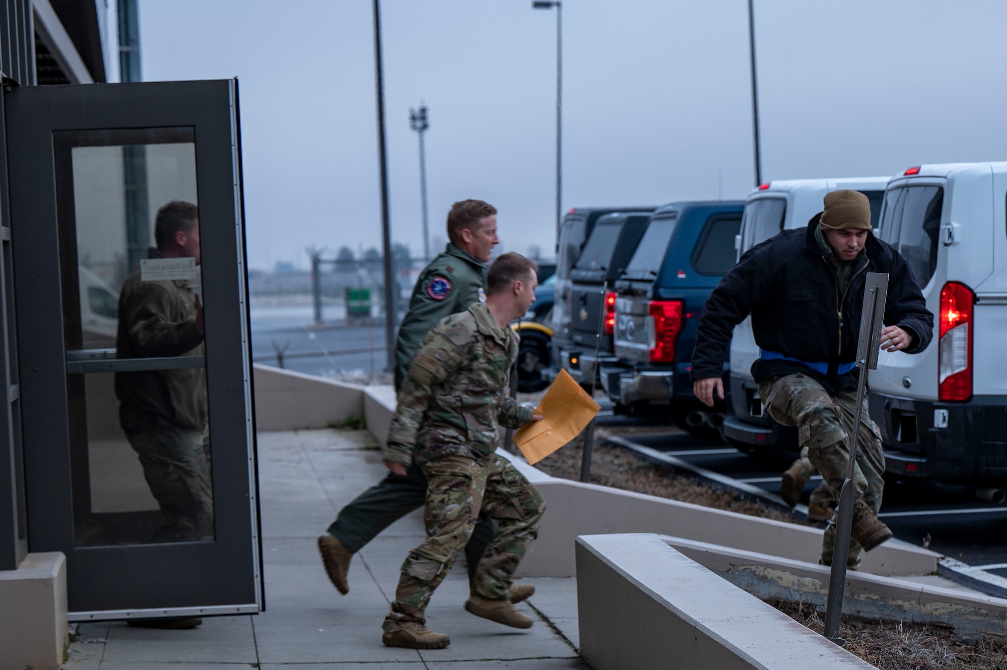Airmen run to their cars.