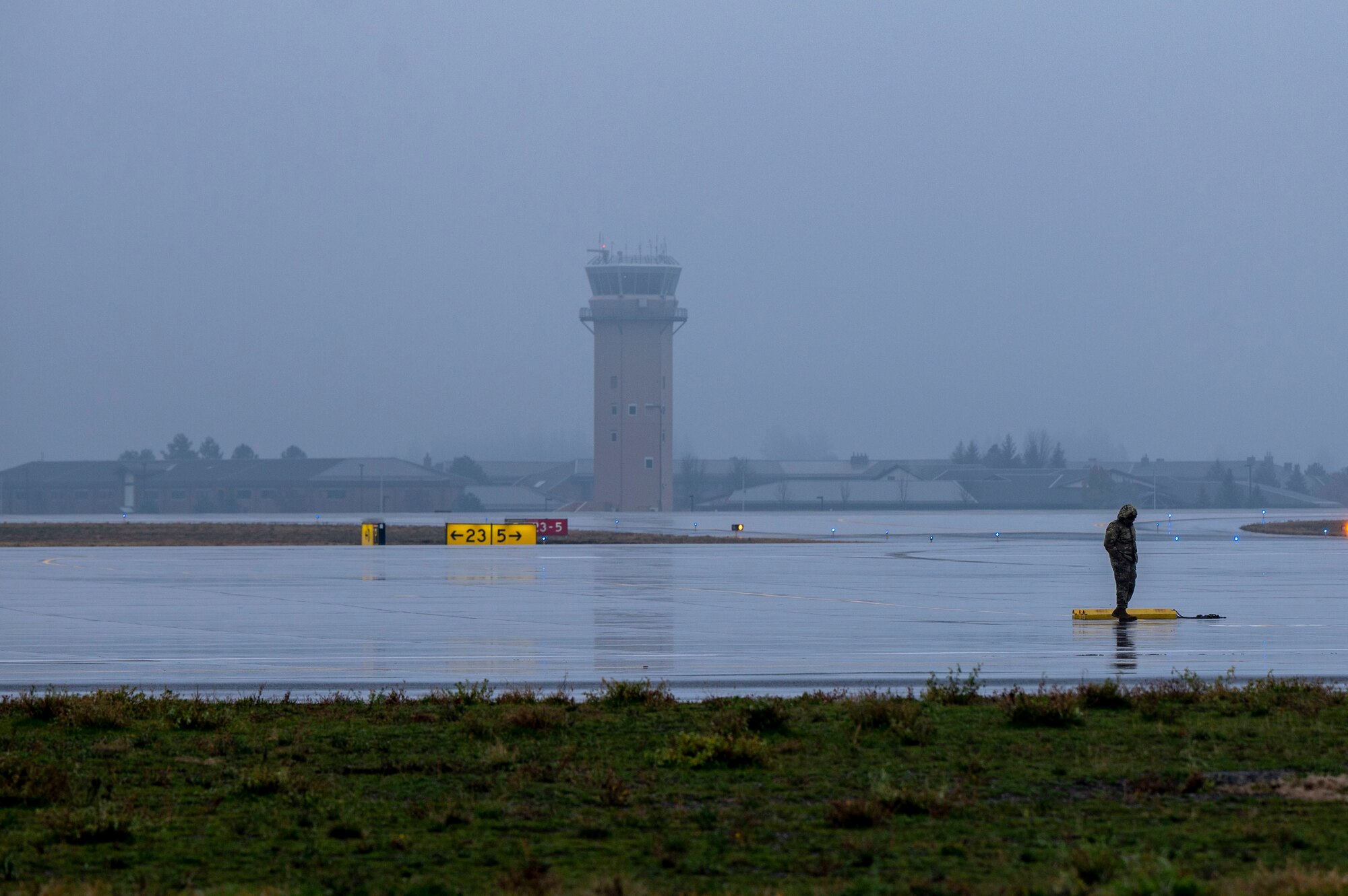 An Airman stands on the flightline