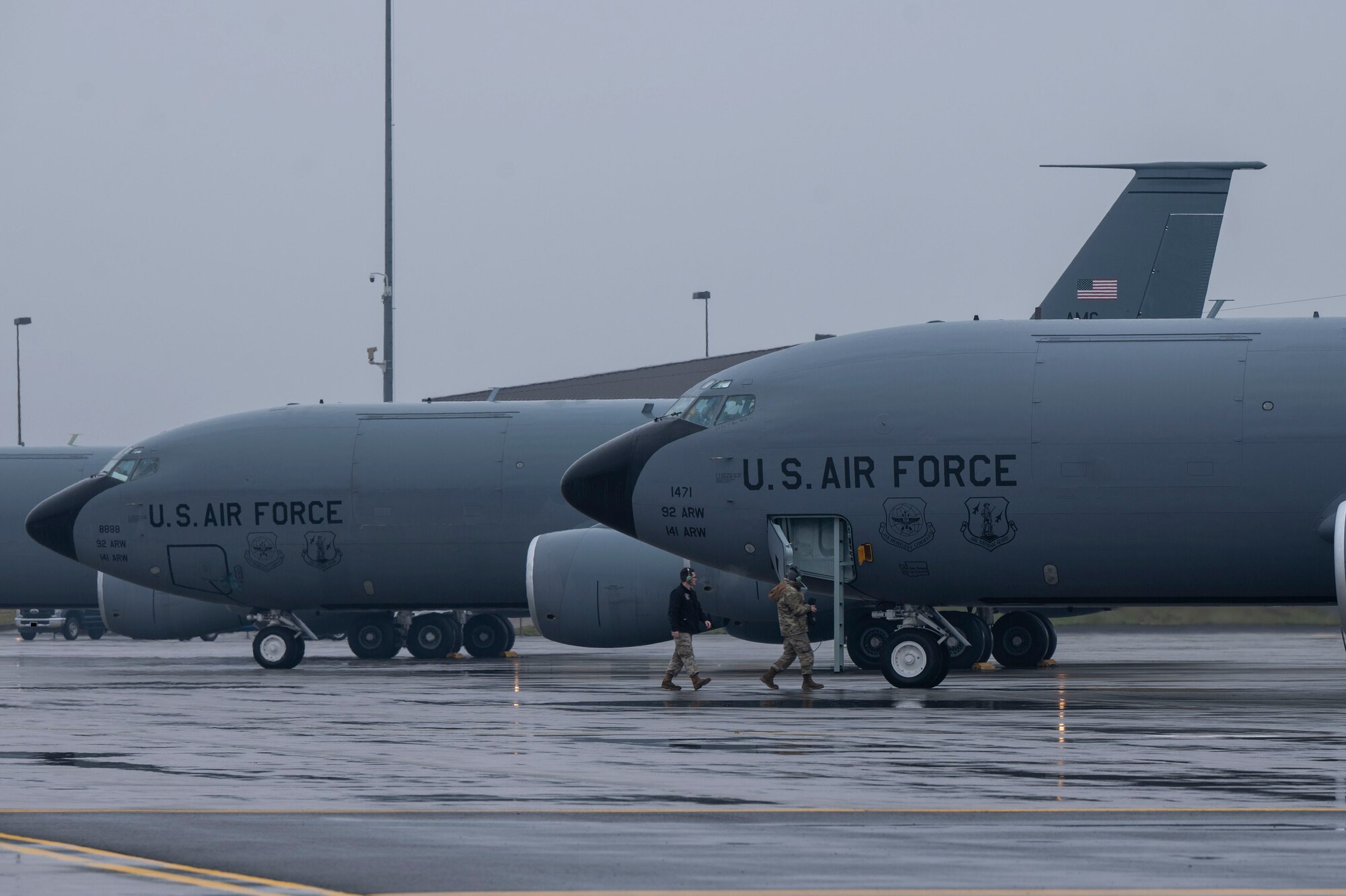 Airmen walk up the ladder of an aircraft.