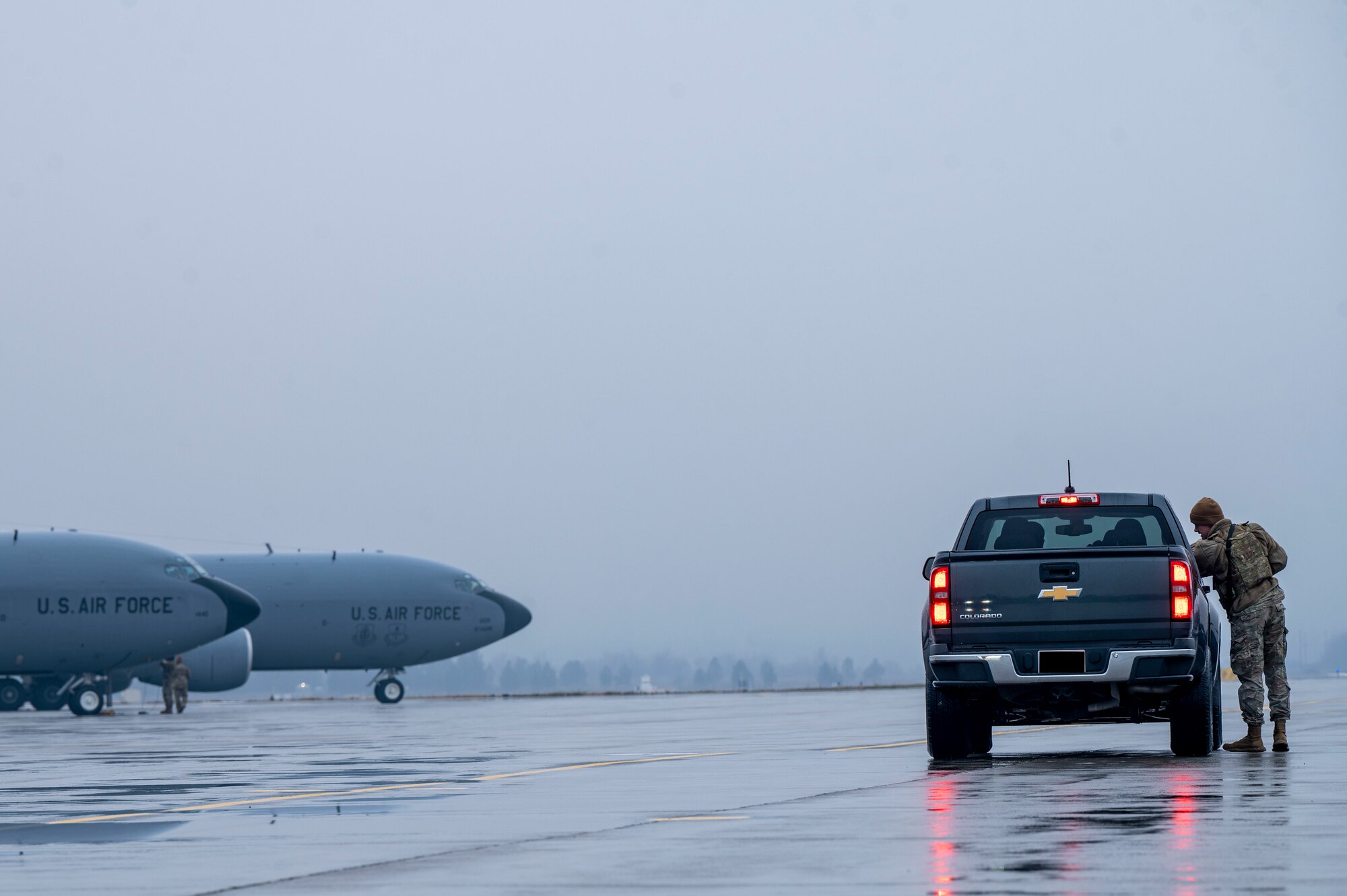 An Airman talks to someone inside of a truck.
