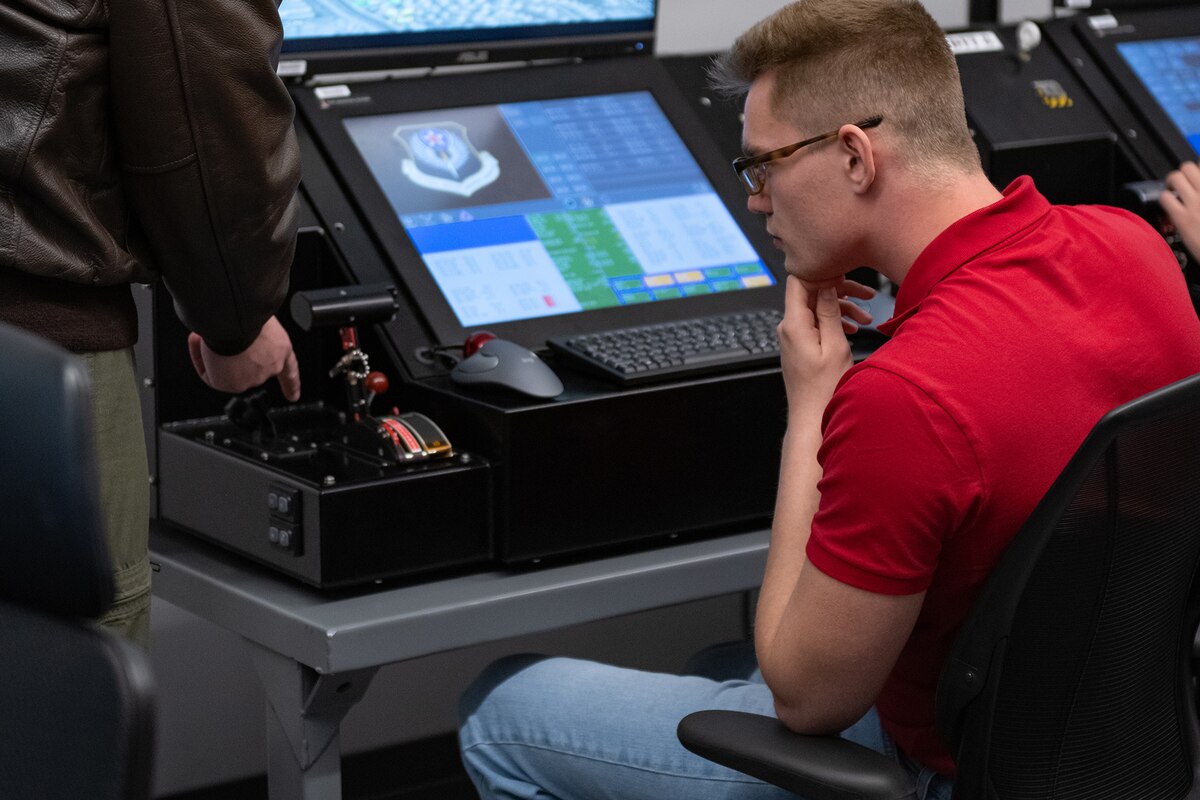 People work on computer monitors.