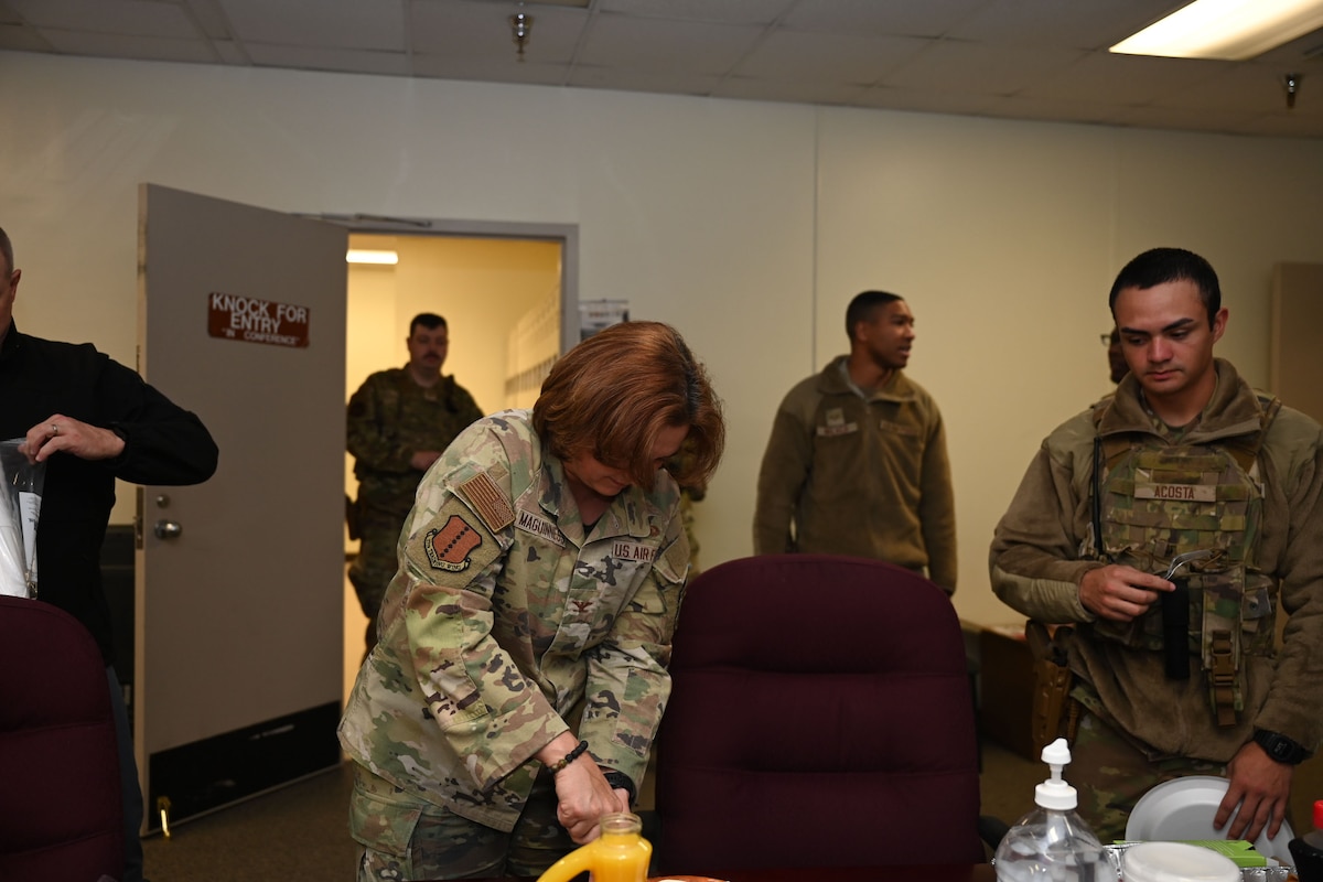 U.S Air Force Col. Angelina Maguinness, 17th Training Wing commander, cuts a slice of homemade cheesecake for Airmen on Thanksgiving morning at the 17th Security Forces Squadron building, Goodfellow Air Force Base, Texas, Nov. 23, 2023. Maguinness made her family recipe for Goodfellow's defenders, working hard to support the 17th TRW mission. (U.S. Air Force photo by Airman 1st Class Evelyn D’Errico)